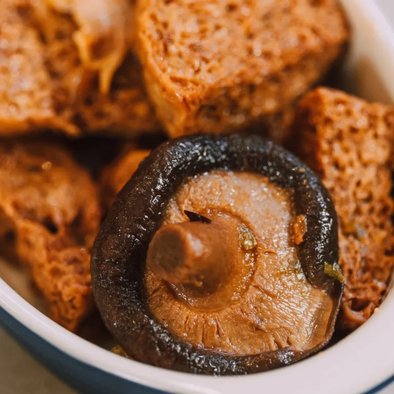 Braised tofu cubes with edamame and scallions in a shallow pan