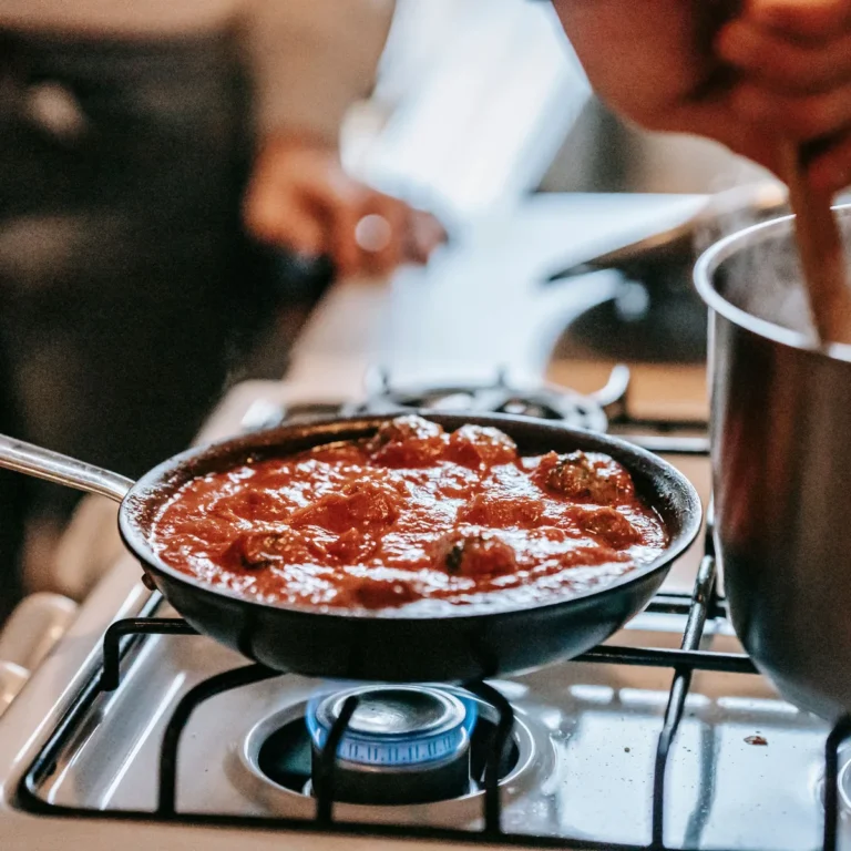 Turkey meatballs simmering in tomato sauce in a pan