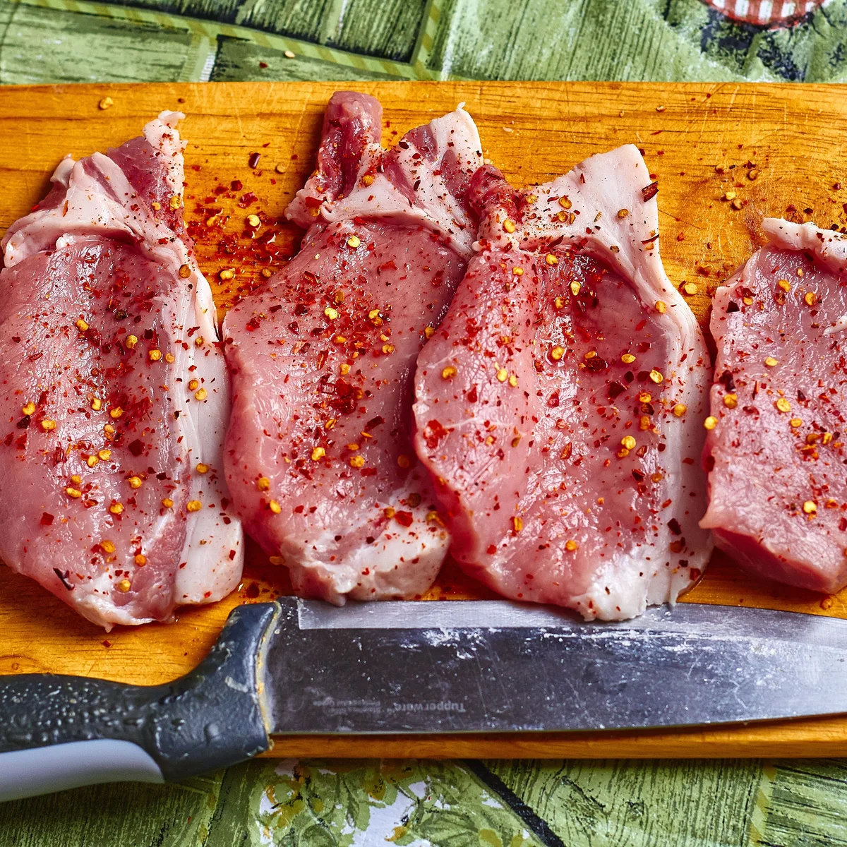 Seared pork chops with sauteed apple and onion slices in a skillet