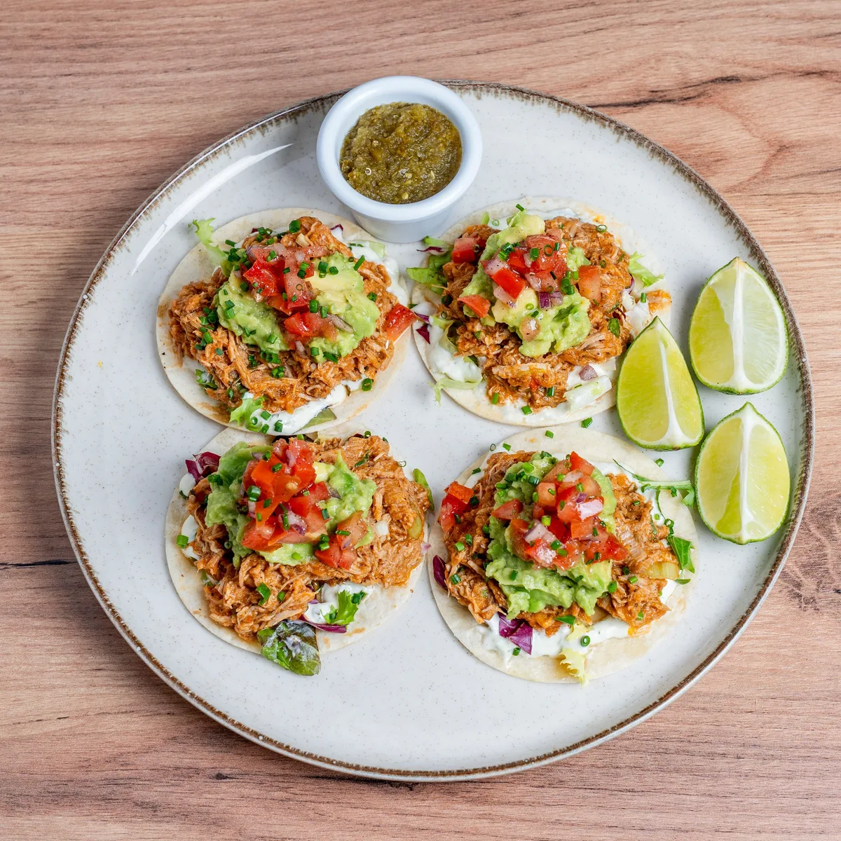 Shredded salsa chicken in a skillet with peppers and cilantro