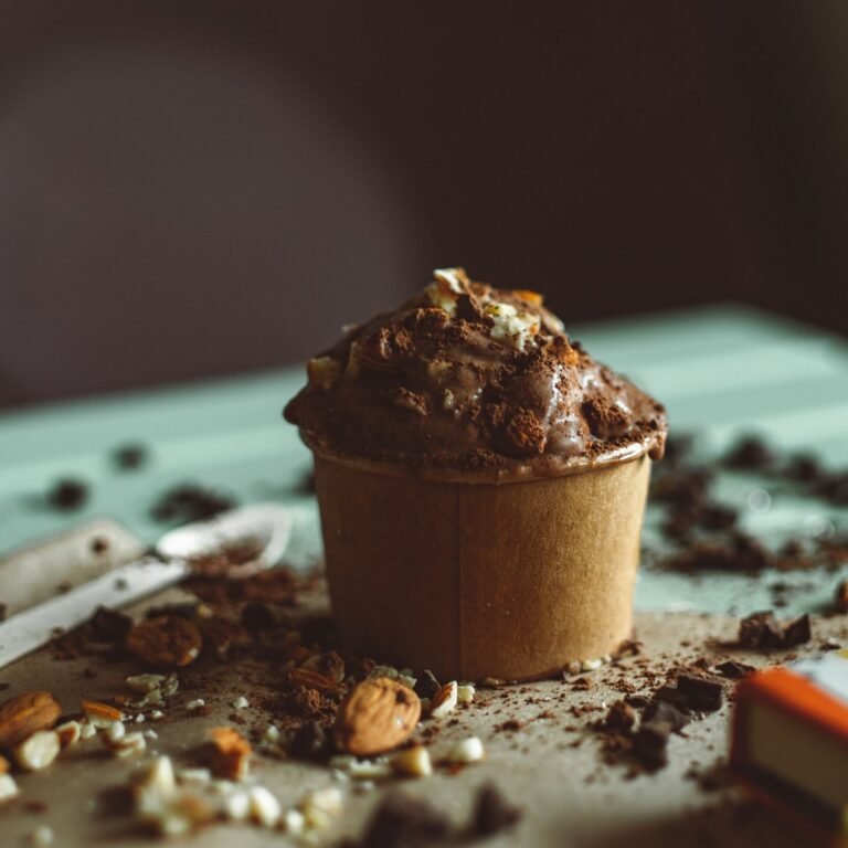 Scoops of dark chocolate no-churn ice cream studded with chopped chocolate chunks in a chilled dish