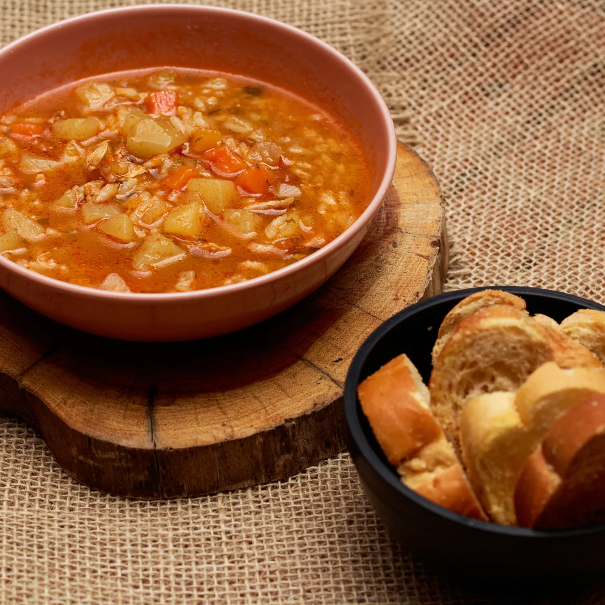 A hearty bowl of vegetable soup with carrots and potatoes