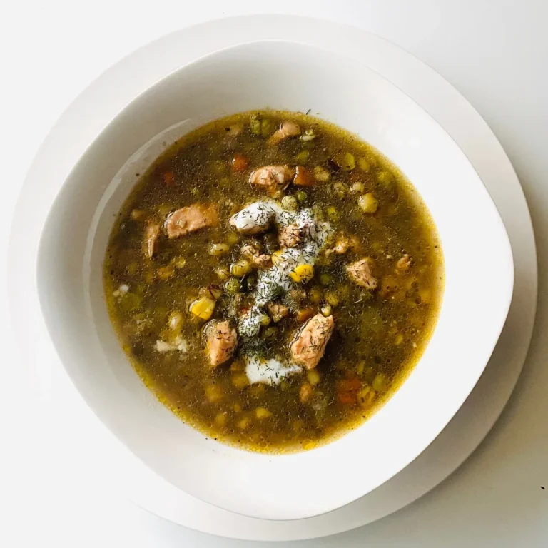 A bowl of green chile stew with tender chunks of meat in a thick green sauce