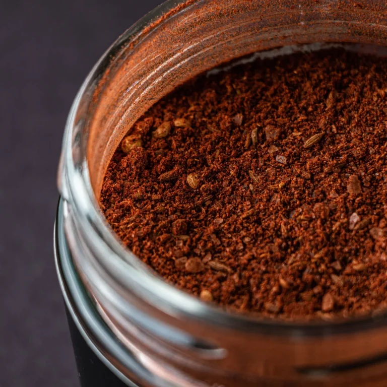 Close-up of a glass jar filled with ground red chili spice blend